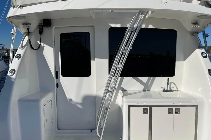 Slide: The Image of 2003 Henriques Yachts 35 Sportfisherman, rear view with ladder and sink. - 4