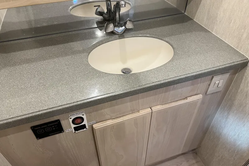 Slide: The Image of Bathroom sink area in a 2003 Henriques Yachts 35 Sportfisherman, featuring a modern faucet. - 43