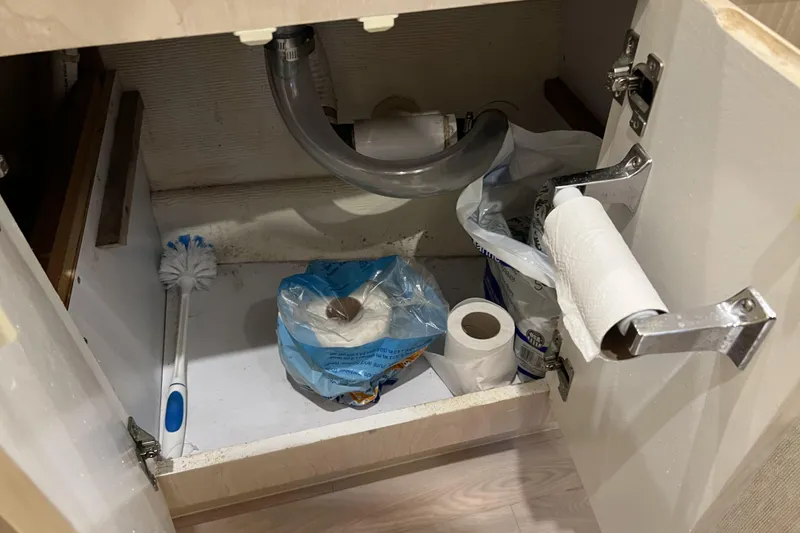 Slide: The Image of Under-sink storage with cleaning supplies and toilet paper on a Henriques Yachts 35 Sportfisherman. - 44