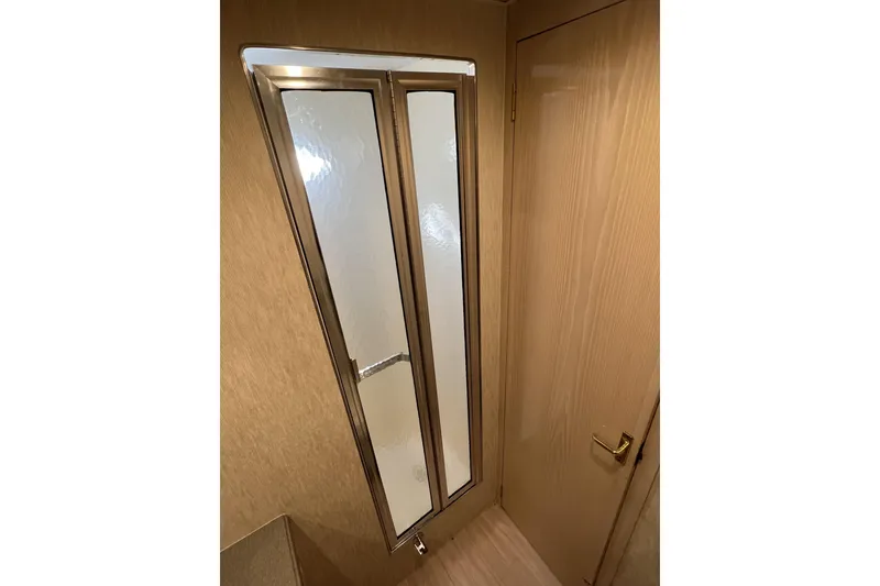 Slide: The Image of Interior of 2003 Henriques Yachts 35 Sportfisherman, featuring a wooden door and window. - 46