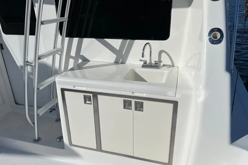 Slide: The Image of 2003 Henriques Yachts 35 Sportfisherman with onboard sink and storage cabinets. - 5