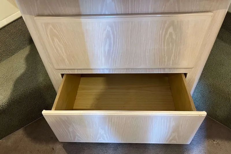 Slide: The Image of Open wooden drawer inside 2003 Henriques Yachts 35 Sportfisherman, showcasing interior storage. - 58