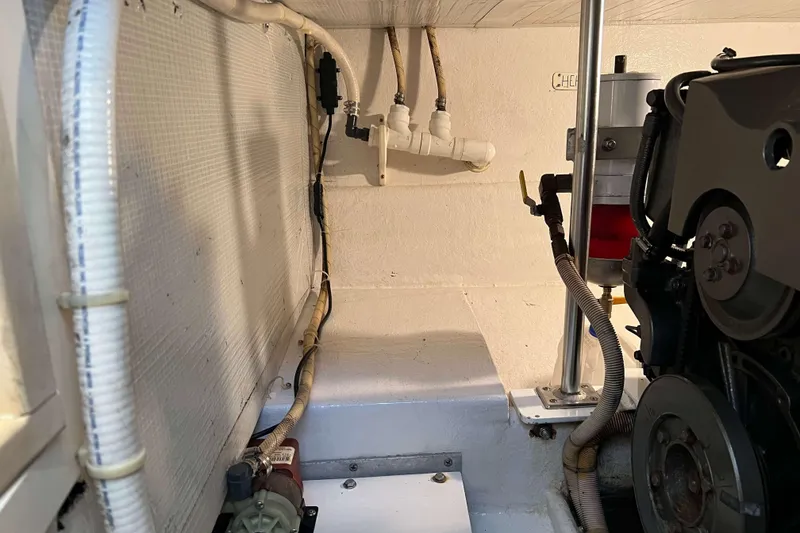 Slide: The Image of Engine room of 2003 Henriques Yachts 35 Sportfisherman, showing mechanical components and wiring. - 65