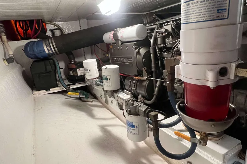 Slide: The Image of Engine room of 2003 Henriques Yachts 35 Sportfisherman, showcasing filters and mechanical components. - 66