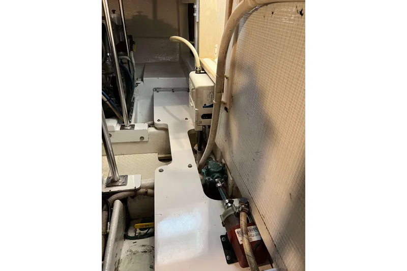 Slide: The Image of Engine room of 2003 Henriques Yachts 35 Sportfisherman, showcasing mechanical components and piping. - 69