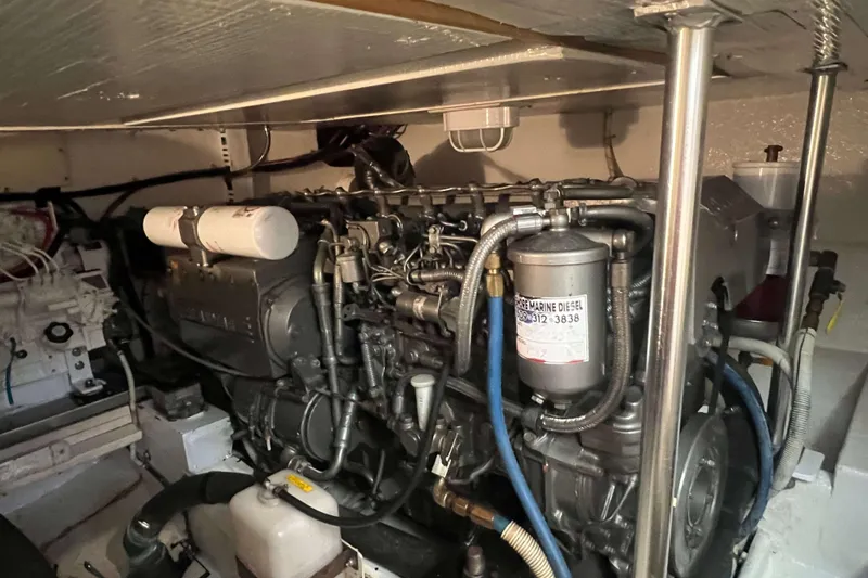 Slide: The Image of Engine room of 2003 Henriques Yachts 35 Sportfisherman, showcasing marine diesel engine components. - 70