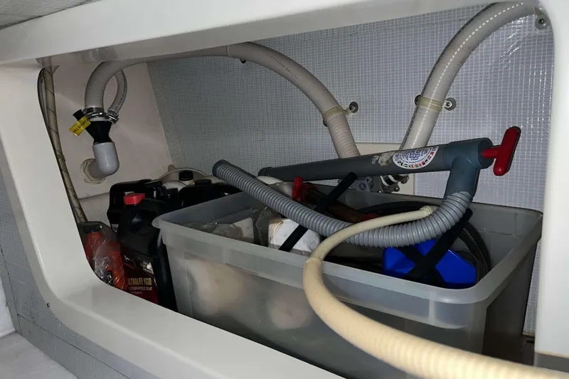 Slide: The Image of Storage compartment in a 2003 Henriques Yachts 35 Sportfisherman with hoses and containers. - 73