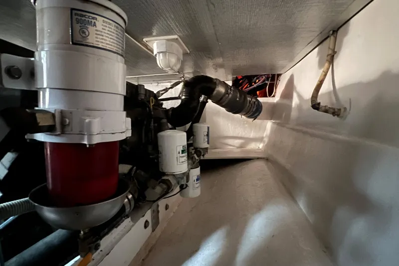 Slide: The Image of Engine compartment of 2003 Henriques Yachts 35 Sportfisherman, featuring fuel filters and hoses. - 75