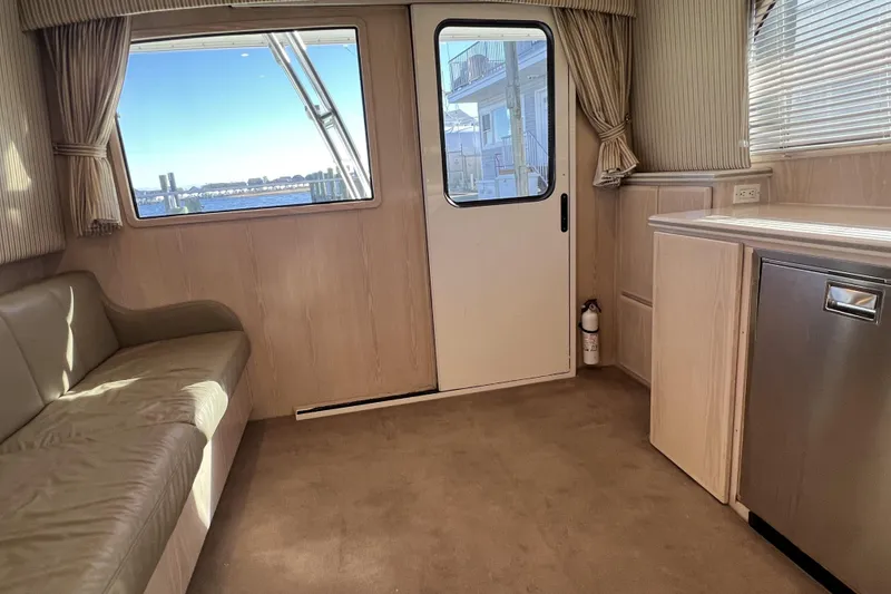 Slide: The Image of Interior of 2003 Henriques Yachts 35 Sportfisherman with sofa, cabinetry, and window view. - 79