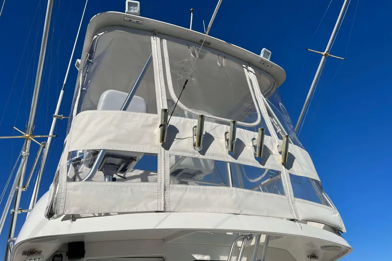 Slide: The Image of 2003 Henriques Yachts 35 Sportfisherman with clear enclosure against blue sky. - 82