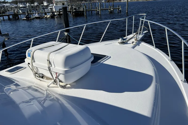 Slide: The Image of 2003 Henriques Yachts 35 Sportfisherman bow with life raft, docked at marina. - 94