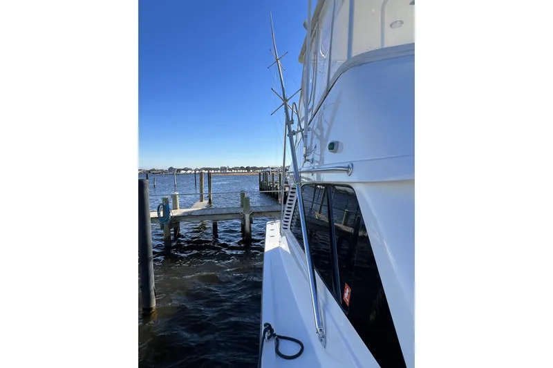 Slide: The Image of 2003 Henriques Yachts 35 Sportfisherman docked by the water on a clear day. - 97
