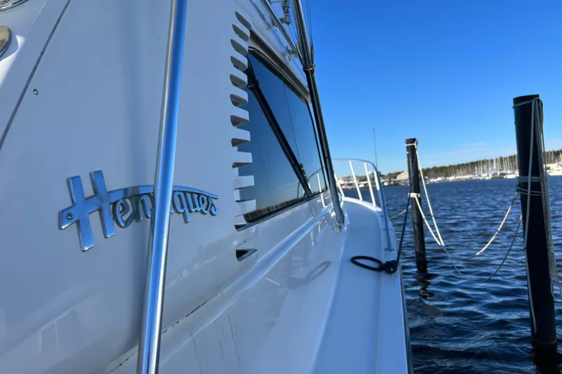 Slide: The Image of 2003 Henriques Yachts 35 Sportfisherman docked by the water on a sunny day. - 98