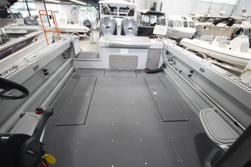 Slide: The Image of 2025 Weldcraft 300 Cuddy King OS boat interior with spacious deck and custom trailer. - 10