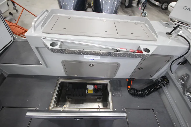 Slide: The Image of 2025 Weldcraft 300 Cuddy King OS boat interior with storage compartments and custom trailer. - 12