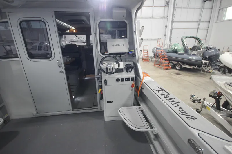 Slide: The Image of Interior view of 2025 Weldcraft 300 Cuddy King OS boat with Garmin navigation system. - 18