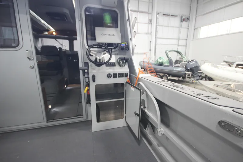 Slide: The Image of Interior view of 2025 Weldcraft 300 Cuddy King OS boat with Garmin navigation system. - 19