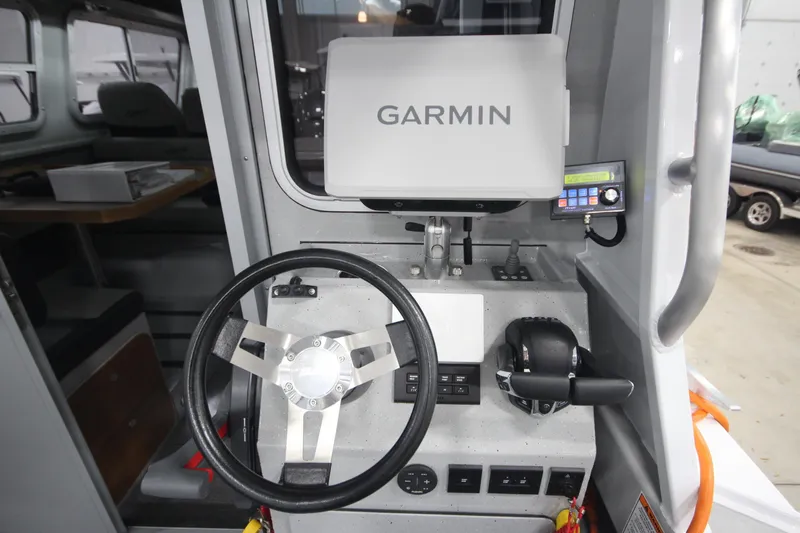 Slide: The Image of 2025 Weldcraft 300 Cuddy King OS helm with Garmin navigation system and controls. - 20