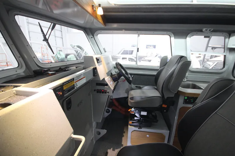 Slide: The Image of Interior of 2025 Weldcraft 300 Cuddy King OS boat with modern helm and seating. - 28