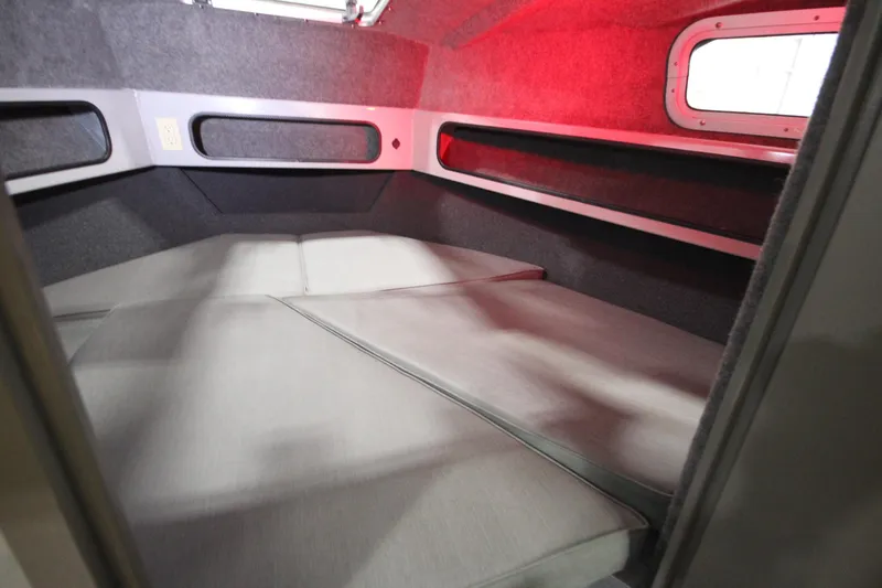 Slide: The Image of 2025 Weldcraft 300 Cuddy King OS cabin interior with cushioned sleeping area. - 38