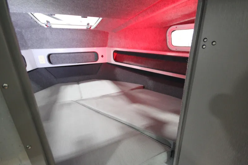 Slide: The Image of Interior cabin of 2025 Weldcraft 300 Cuddy King OS, featuring cozy sleeping area. - 39
