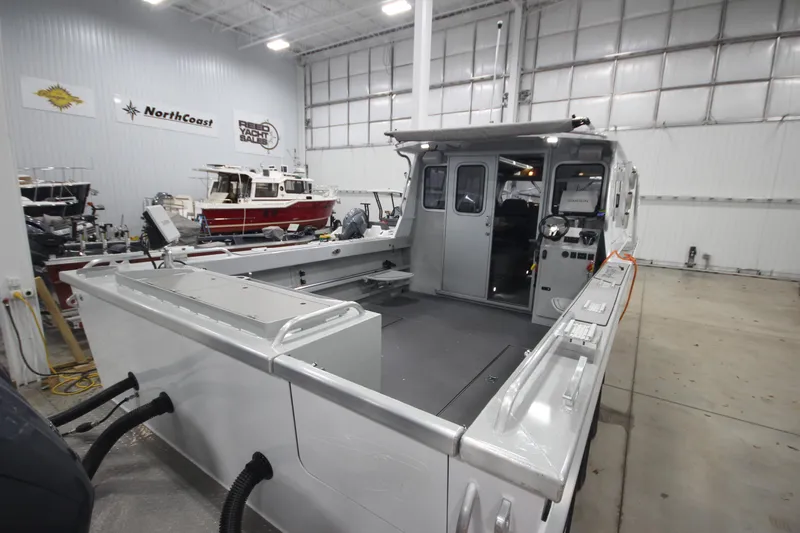 Slide: The Image of 2025 Weldcraft 300 Cuddy King OS boat in showroom with custom trailer. - 9