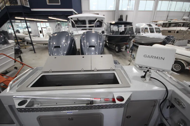 Slide: The Image of 2025 Weldcraft 300 Cuddy King OS with Garmin system and twin engines in showroom. - 11