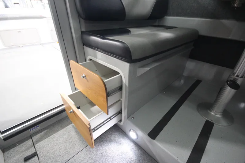 Slide: The Image of Interior of 2025 Weldcraft 300 Cuddy King OS with open storage drawers. - 30