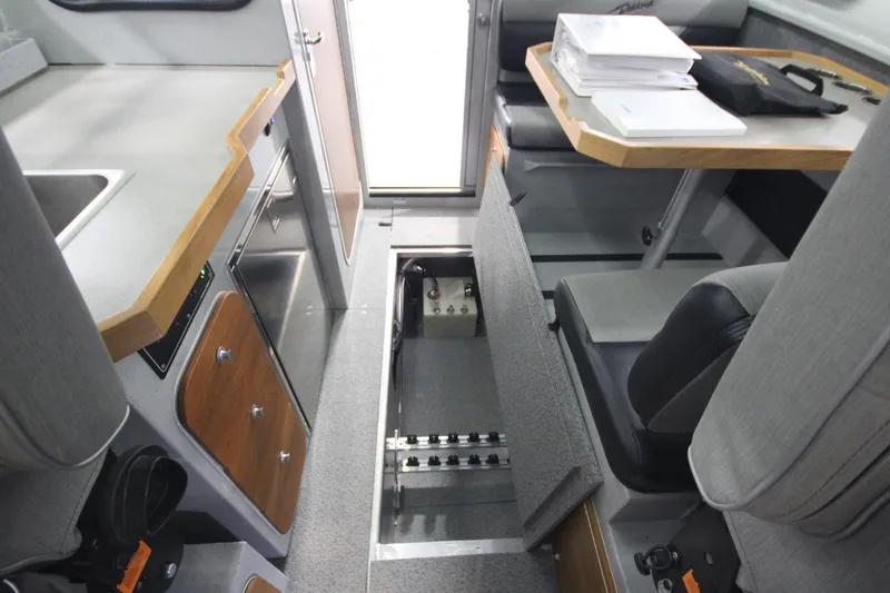 Slide: The Image of Interior of 2025 Weldcraft 300 Cuddy King OS boat, featuring seating and storage. - 33