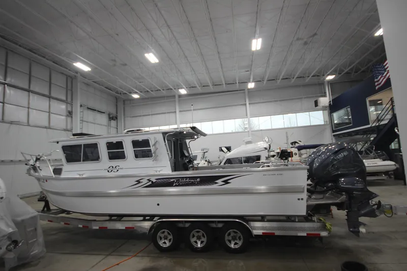 Slide: The Image of 2025 Weldcraft 300 Cuddy King OS with twin 425 engines on custom trailer in showroom. - 4