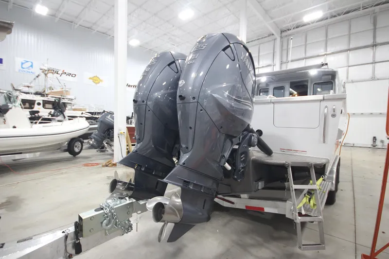 Slide: The Image of 2025 Weldcraft 300 Cuddy King OS with twin 425 engines on custom trailer in showroom. - 7