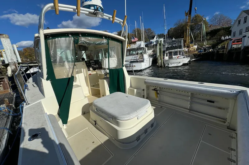 Slide: The Image of 1999 Albin 28 Tournament Express boat docked, featuring spacious deck and cabin area. - 4