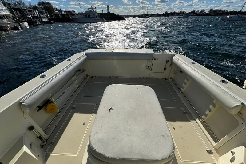 Slide: The Image of 1999 Albin 28 Tournament Express boat interior with seating, docked by the water. - 6