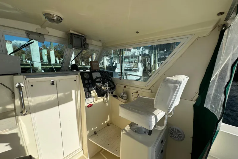 Slide: The Image of Interior of 1999 Albin 28 Tournament Express boat with steering wheel and navigation equipment. - 7
