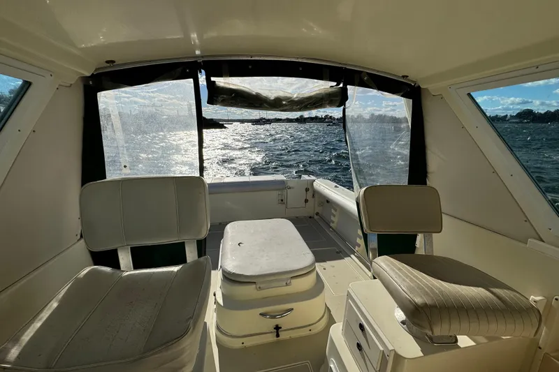 Slide: The Image of Interior view of 1999 Albin 28 Tournament Express boat with seating and water backdrop. - 8
