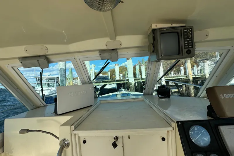 Slide: The Image of Interior view of 1999 Albin 28 Tournament Express boat cockpit with navigation equipment. - 9