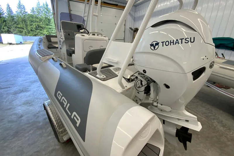Slide: The Image of 2026 Gala V500 boat with Tohatsu engine in a garage setting. - 18