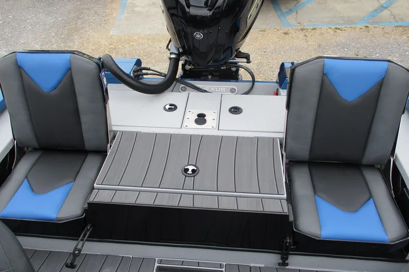 Slide: The Image of 2026 Vexus AVX1985S boat interior with blue and gray seating and motor. - 12