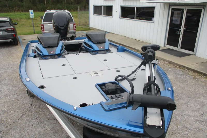 Slide: The Image of 2026 Vexus AVX1985S fishing boat with blue trim, parked outside a building. - 3