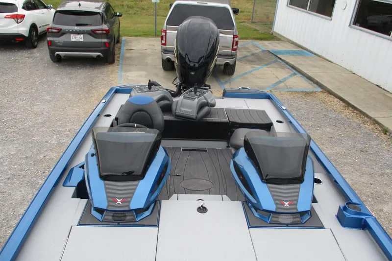 Slide: The Image of 2026 Vexus AVX1985S boat with dual consoles and sleek design in a parking area. - 5