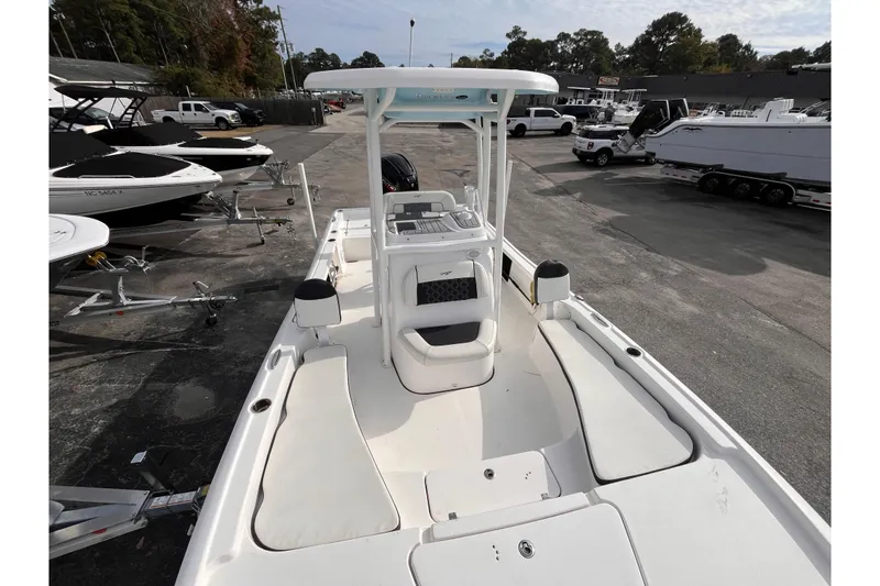 Slide: The Image of 2023 Tidewater 2210 Carolina Bay boat, white interior, parked in a marina lot. - 12