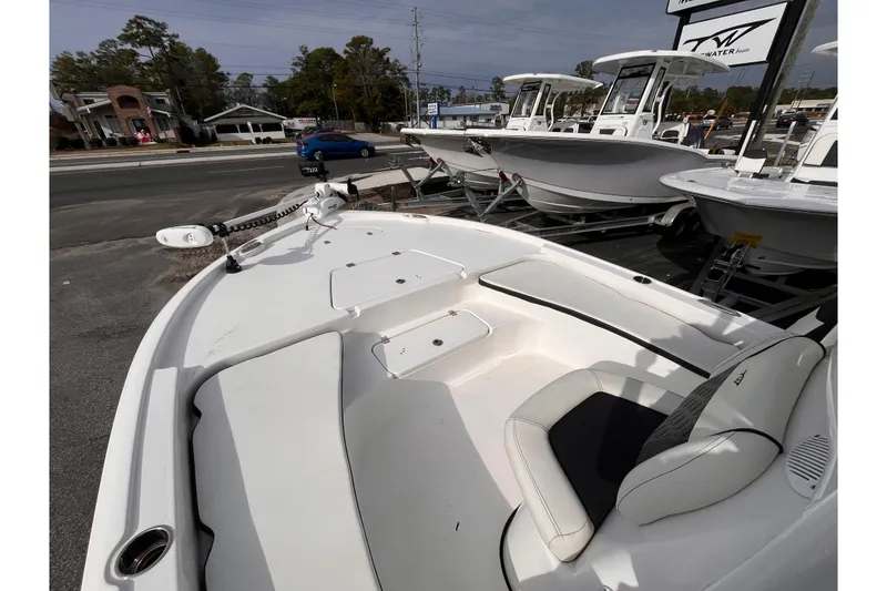 Slide: The Image of 2023 Tidewater 2210 Carolina Bay boat on display at a dealership. - 13