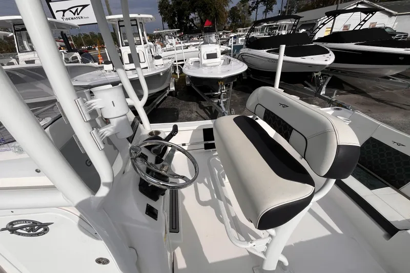 Slide: The Image of 2023 Tidewater 2210 Carolina Bay boat interior with steering wheel and seating. - 15