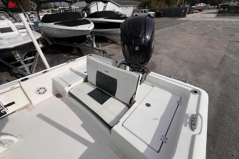 Slide: The Image of 2023 Tidewater 2210 Carolina Bay boat with Yamaha outboard motor in a marina setting. - 16