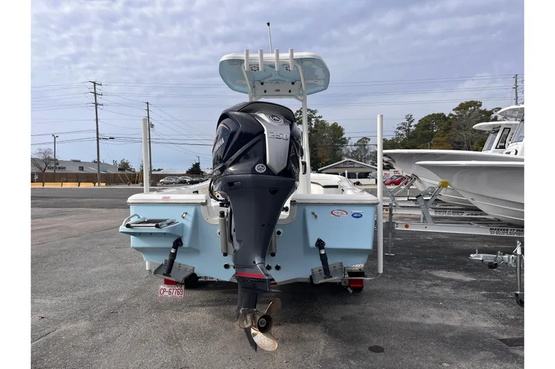 Slide: The Image of 2023 Tidewater 2210 Carolina Bay boat with Yamaha outboard motor, parked on a trailer. - 3