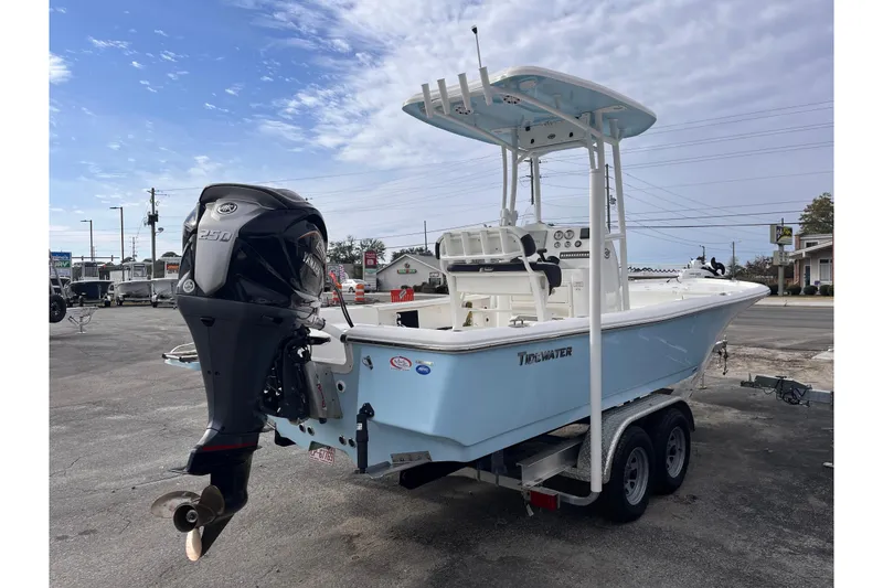 Slide: The Image of 2023 Tidewater 2210 Carolina Bay boat on trailer, featuring Yamaha 250 engine. - 4