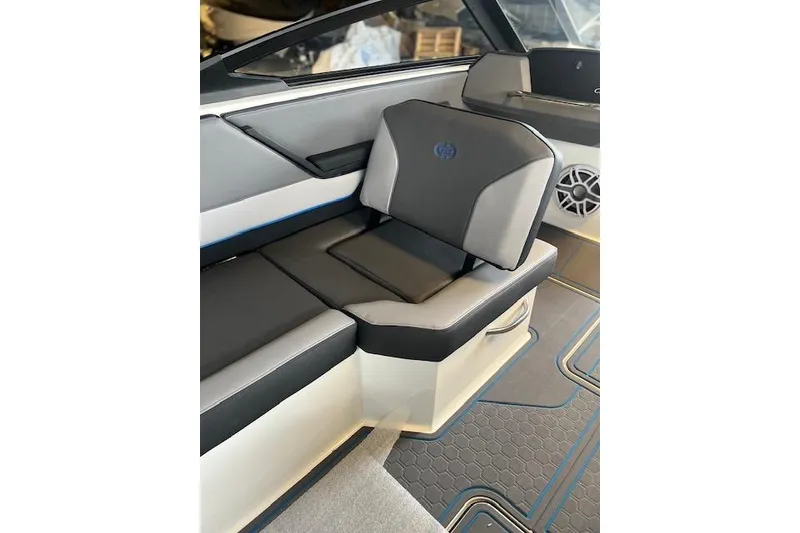 Slide: The Image of 2025 Cobalt CS23 Surf boat interior with sleek black and gray seating. - 10