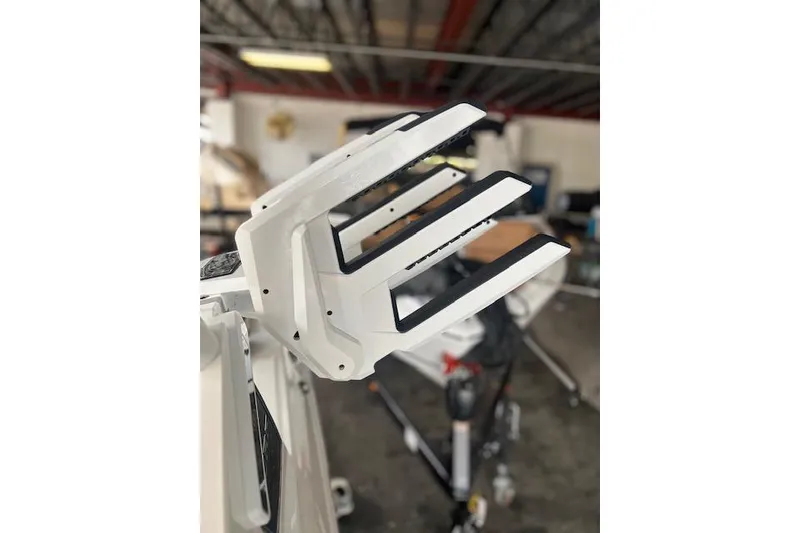 Slide: The Image of 2025 Cobalt CS23 Surf boat with a focus on a white wakeboard rack. - 13