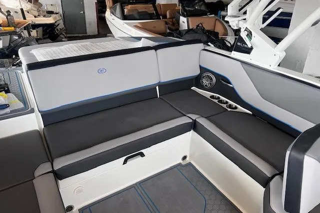 Slide: The Image of 2025 Cobalt CS23 Surf boat interior with gray seating and cup holders. - 15