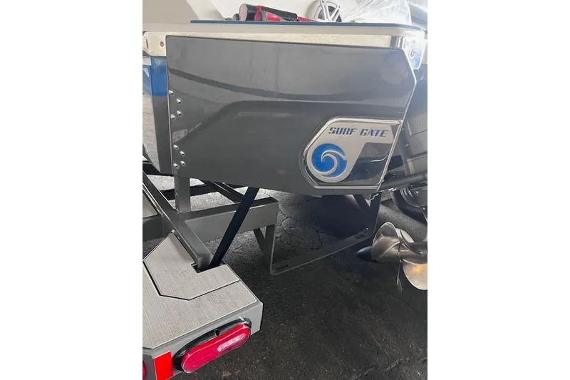 Slide: The Image of 2025 Cobalt CS23 Surf boat with Surf Gate technology, rear view. - 23